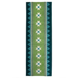 Green runner rug handwoven from New Zealand wool with a geometric design of star motifs and a zig zag border inspired by Victorian tiles.