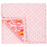 The reverse of the pink coral reef baby quilt features a pretty white and light pink fish scale pattern.