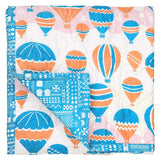 Balloons at Dawn Baby quilt hand printed with a hot air balloon print pattern in cheerful blue and orange.