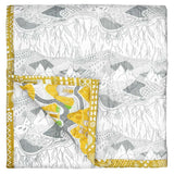 The reverse of the Cave House baby quilt is handprinted with a light grey Valley View illustrated landscape print.