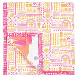 The reverse of the Fairy Chimney Baby Quilt features a pink and yellow pattern inspired by rock-cut carvings in Cappadocia, Turkey.