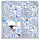 The reverse of the Horse Ranch baby quilt with a blue, white and grey print of trees decorated with Evil Eye amulets inspired by travels in Turkey