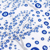 Close up of the reverse of the Horse Ranch baby quilt handprinted with trees decorated with Evil Eye amulets.