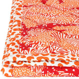 Detail of camo and animal print Big Cat Camo quilt handprinted in shades of orange and red.