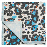 Rockpool baby quilt handprinted with illustrations of a beach scene in seaside colours of blue, white and grey with pops of red.