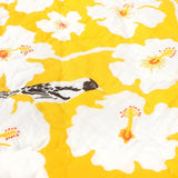 Detail of the yellow weaver baby quilt handprinted with birds and flowers.