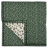 The reverse of the Green Pine baby quilt with a dark forest green 'mini pine' print pattern.
