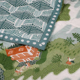 Detail of the Mountain Zig zag baby quilt hand printed with illustrations inspired by alpine life in the Himalayas.