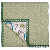 The reverse of the Winding Roads Cotton Baby Quilt with light green nature inspired 'mini pine' print.
